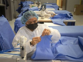 Workers in the production of medical gowns are seen at Harbour Technologies on Thursday, Oct. 28, 2021.