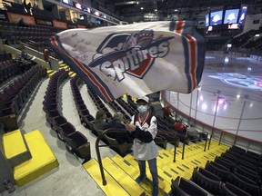 Dominic Legace ,12, waves the home team flag at the Windsor Spitfire season opener on Thursday, October 7, 2021 at the WFCU Centre.