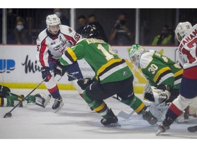 Windsor Spitfires' forward Wyatt Johnston is unable to convert a scoring chance  in front of London Knights' Luke Evangelista and goaltender, Brett Brochu during Monday's game at the WFCU Centre.
