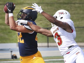 WINDSOR, ONTARIO. OCTOBER 2, 2021 - Bennett Vani, left, of the University of Windsor intercepts a pass intended for A.J. Chase of the University of Guelph on Saturday, October 2, 2021 at the Alumni Field in Windsor.