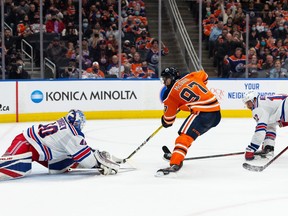 Edmonton Oilers’ Connor McDavid scores a late game goal on New York Rangers’ goaltender Alexandar Georgiev on Friday night.