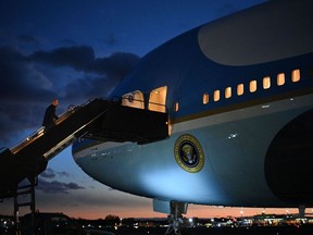 US President Joe Biden boards Air Force One before departing Manchester-Boston Regional Airport in Manchester, New Hampshire on November 16, 2021. - Joe Biden earlier visited a creaky bridge in New Hampshire to tout his rare victory in passing a bipartisan infrastructure package, hoping the $1 trillion measure will also put his own presidency back on the road.