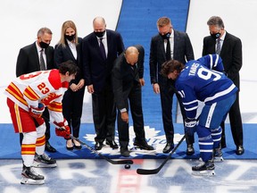 Jerome Iginla drops the ceremonial first puck along with Doug Wilson, Kim St-Pierre, Kevin Lowe, Marian Hossa and Ken Holland to honor their induction to the Hockey Hall of Fame at the Scotiabank Arena on November 12, 2021 in Toronto, Ontario, Canada.