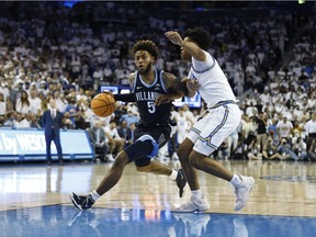 LOS ANGELES, CALIFORNIA - NOVEMBER 12: Justin Moore #5 of the Villanova Wildcats drives against Jaylen Clark #0 of the UCLA Bruins during the second half at UCLA Pauley Pavilion on November 12, 2021 in Los Angeles, California.