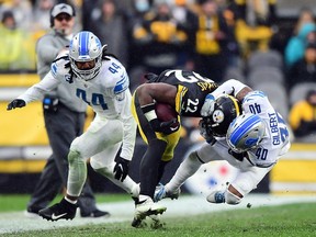 Mark Gilbert of the Detroit Lions tackles Najee Harris of the Pittsburgh Steelers during the fourth quarter at Heinz Field on November 14, 2021 in Pittsburgh, Pennsylvania.