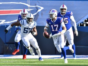 Buffalo Bills quarterback Josh Allen runs from Indianapolis Colts defensive end Kemoko Turay.