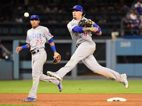 Javier Baez of the Chicago Cubs makes a throw to first in the seventh inning against the Los Angeles Dodgers in game five of the National League Division Series at Dodger Stadium on October 20, 2016 in Los Angeles, California.