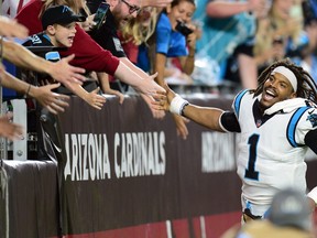 Carolina Panthers quarterback Cam Newton celebrates with fans after defeating the Arizona Cardinals at State Farm Stadium.