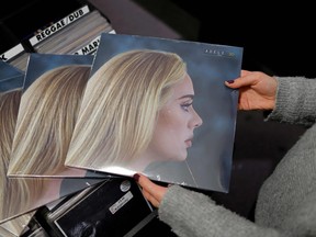 A member of staff sorts copies of the new album from British singer-songwriter Adele, "30" in Sister Ray record store in the soho area of central London on Nov. 19, 2021.