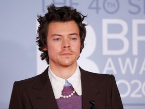 British singer-songwriter Harry Styles poses on the red carpet on arrival for the BRIT Awards in London on Feb. 18, 2020.