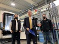 Vic Fedeli (center), Ontario minister of economic development, talks about how provincial grants have benefited the automated manufacturing of Lakeshore-based tool and mold company CNCTech.com, owned by Donny Butler (left) and his brother Kevin Butler (right). Photographed Nov. 16, 2021.