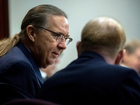 Defence attorney Franklin Hogue, right, speaks with defendant Travis McMichael during a motion hearing of his trial at the Glynn County Courthouse in Brunswick, Ga., Nov. 4, 2021.