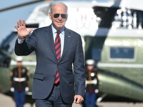 US President Joe Biden makes his way to board Air Force One before departing from Andrews Air Force Base in Maryland on November 16, 2021. - Biden is headed to Woodstock, New Hampshire to promote his infrastructure bill.