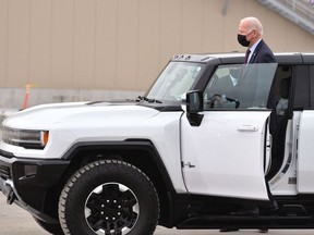 US President Joe Biden test drives a GMC Hummer EV as he tours the General Motors Factory ZERO electric vehicle assembly plant in Detroit, Michigan on November 17, 2021.