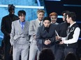 This handout photo courtesy of American Broadcasting Companies, Inc. / ABC shows (L-R) J-Hope, V, RM, Jimin, Suga, and Jungkook of South Korean band BTS accept the Artist of the Year award onstage during the 2021 American Music Awards at the Microsoft Theater on November 21, 2021 in Los Angeles.