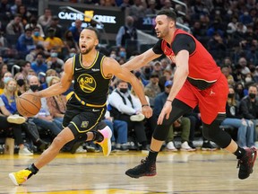Golden State Warriors guard Stephen Curry drives past Portland Trail Blazers forward Larry Nance Jr. during the fourth quarter at Chase Center.