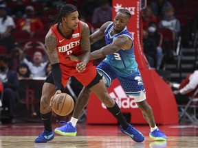 Charlotte Hornets guard Terry Rozier defends against Houston Rockets guard Kevin Porter Jr. during overtime at Toyota Center.