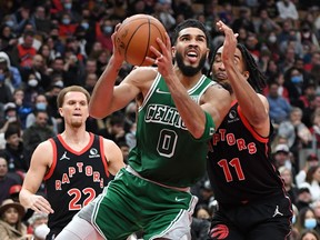 Boston Celtics forward Jayson Tatum drives to the basket past Toronto Raptors forward Justin Champagnie in the second half at Scotiabank Arena.