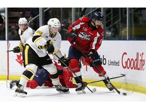 Windsor Spitfires' Nathan Ribau, right, battles Sarnia Sting's Alex Geci in the first period at Progressive Auto Sales Arena in Sarnia, Ont., on Friday, Nov. 12, 2021. Mark Malone/Chatham Daily News/Postmedia Network