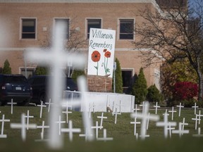 Crosses in honour of veterans are seen on the front lawn at Villanova Catholic Secondary School, on Monday, Nov. 8, 2021.