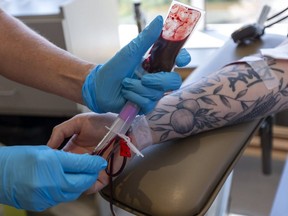 A man donates blood at the Canadian Blood Services donor centre in London, Ont, Aug. 4, 2020.