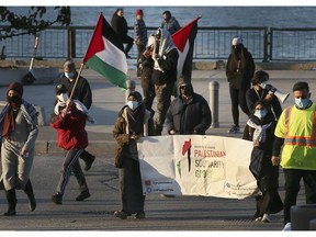 A group of University of Windsor students and their supporters gather at Ouellette Avenue and Riverside Drive on Saturday, Nov. 6, 2021, to protest conditions for some Palestinian prisoners.