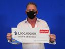 Glenn Weitz of Windsor holds his $3M prize cheque that he won playing Instant Triple Millions.