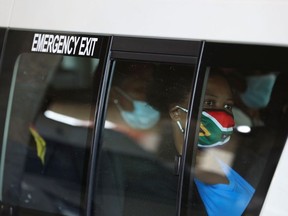 A passenger in a taxi wears a face mask with colours of the South African flag after the announcement of a British ban on flights from South Africa because of the detection of a new coronavirus disease (COVID-19) variant, in Soweto, South Africa, November 26, 2021.