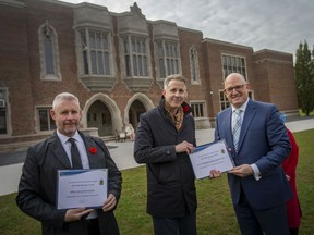 Scott Weir, principal architect at ERA Architects Inc., and Colin McDonald, principal architect from J.P. Thomson Architects Ltd., each receive the Built Heritage Award from Mayor Drew Dilkens outside Kennedy Collegiate, on Thursday, Nov. 4, 2021.