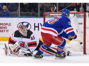 New York Rangers left wing Chris Kreider scores a goal on New Jersey Devils goaltender Jonathan Bernier for the win during shoot outs at Madison Square Garden.