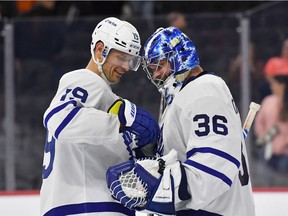 Toronto Maple Leafs centre Jason Spezza (19) hands the puck to  goaltender Jack Campbell (36) after shutout win against the Philadelphia Flyers at Wells Fargo Center in Philadelphia, Nov. 10, 2021.