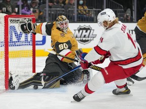 Vegas Golden Knights goaltender Robin Lehner makes a pad save against Carolina Hurricanes center Jordan Staal during the first period at T-Mobile Arena.