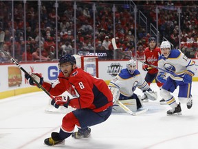 Washington Capitals left wing Alex Ovechkin (8) chases a rebound in front of Buffalo Sabres goaltender Dustin Tokarski (31) during the third period at Capital One Arena in Washington on Nov. 8, 2021.