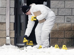 A Windsor Police forensic officer is pictured at the Lexington Inn & Suites hotel in Windsor on Sunday November 28, 2021.