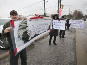 Dave Mota, left, organizer of a Rally for Affordable Housing event, is shown with other participants in Essex on Sunday, Nov. 21, 2021.