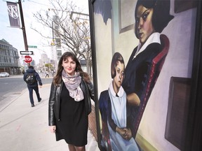 Jennifer Matotek, executive director of the Art Gallery of Windsor, stands by a weatherproof life-sized reproduction of a painting from the AGW collection, mounted in downtown Windsor. Photographed Nov. 11, 2021.