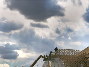 Workers are shown at the construction site of a new house near the WFCU Centre in Windsor on Nov. 4, 2021.