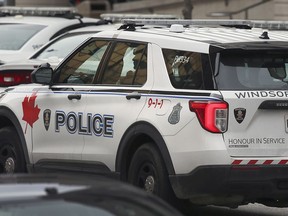 An officer with the Windsor Police Service leaves the downtown headquarters on Friday, Nov. 26, 2021.