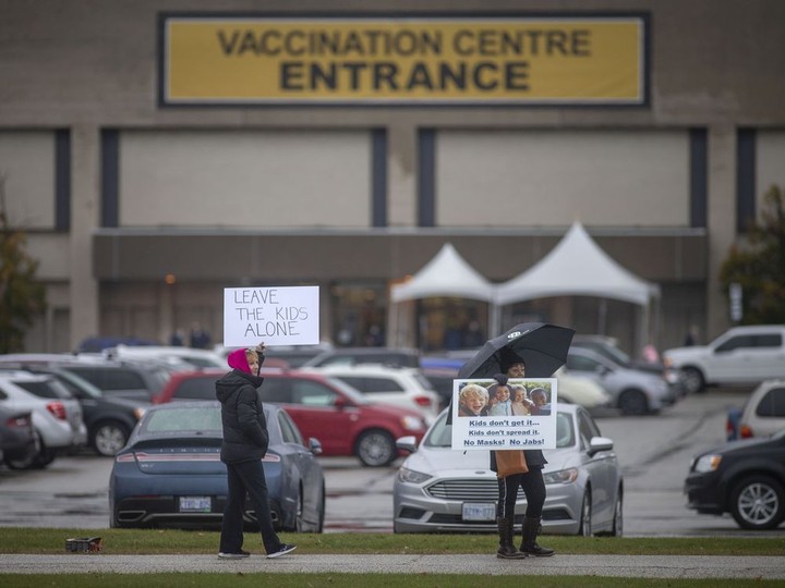  People opposed to the COVID-19 vaccine protest outside Devonshire Mall’s vaccination centre on the first day children aged 5-11 are eligible for the vaccine, on Thursday, Nov. 25, 2021.