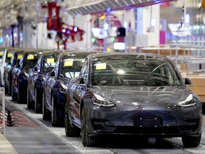 FILE PHOTO: Tesla China-made Model 3 vehicles are seen during a delivery event at its factory in Shanghai, China January 7, 2020.