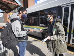 Deante Chase, left, a St. Clair College student speaks with Jessica Bondy, organizer of the Activate Transit Windsor Essex organization at the downtown Transit Windsor terminal on Wednesday, November 3, 2021.