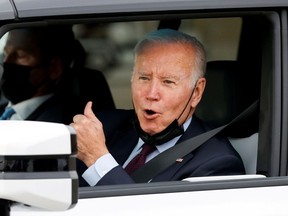 U.S. President Joe Biden gestures after driving a Hummer EV during a tour at the General Motors 'Factory ZERO' electric vehicle assembly plant in Detroit, Michigan, U.S. November 17, 2021.