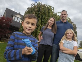 Abel Walker, 6, an amputee, is pictured with his family, Cortney and Ryan Walker, and  sister, Abbey Walker, 9, outside their home on Sunday, Oct. 31, 2021.  Abel is this year's WarAmps representative.