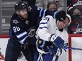 Winnipeg Jets' Pierre-Luc Dubois and Toronto Maple Leafs' Auston Matthews (34) tangle.