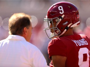 Bryce Young of the Alabama Crimson Tide talks with head coach Nick Saban before a recent game in Tuscaloosa, Ala.