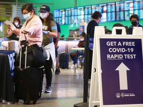 A sign promotes a new rapid COVID-19 testing site for arriving international passengers at Los Angeles International Airport (LAX) on December 3, 2021 in Los Angeles.