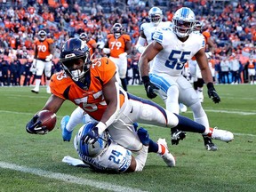 Javonte Williams of the Denver Broncos scores a touchdown reception against Amani Oruwariye of the Detroit Lions during the third quarter at Empower Field At Mile High on December 12, 2021 in Denver, Colorado.