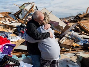 Mike Castle hugs his daughter Nikki Castle after locating the father-daughter necklace he meant to gift to Nikki for Christmas, after the tornado in Dawson Springs, Ky., Saturday, Dec. 11, 2021.
