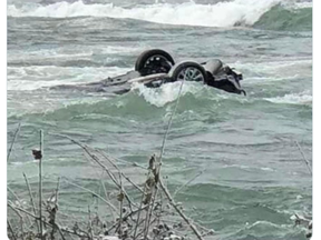 The car involved in a daring rescue at Niagara Falls is now teetering metres from the edge, upside down. (Twitter)