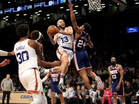 New York Knicks guard Evan Fournier drives to the basket against Brooklyn Nets guard Cam Thomas during the second quarter at Barclays Center.